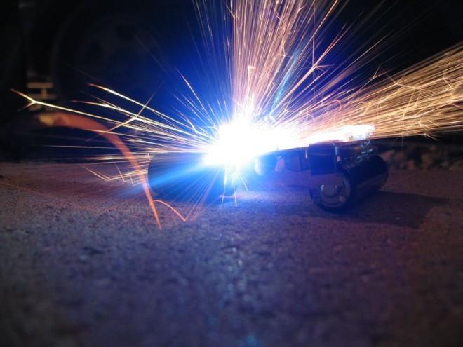 An intense close up photo of an electrical spark. This reaction lights up the room with a bright flash of light and color.